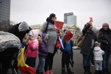 Bucharest, Romania - February 18, 2018: Mothers protest in Victory Square: Dozens of women protested against possible decrease in child rearing allowance.のeditorial素材