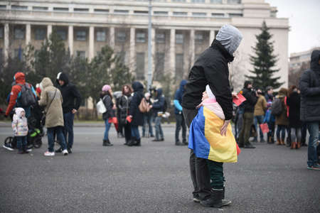 Bucharest, Romania - February 18, 2018: Mothers protest in Victory Square: Dozens of women protested against possible decrease in child rearing allowance.のeditorial素材
