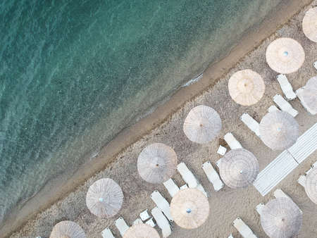 Beach with umbrellas and a bright waterの写真素材