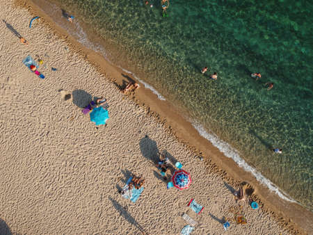 Beach with umbrellas and a bright water