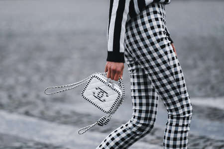 Paris, France - March 5, 2019: Street style - Woman wearing black white striped jumper, plaid pants and Chanel bag,  before a fashion show during Paris Fashion Week - PFWFW19のeditorial素材