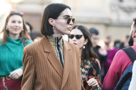 Milan, Italy - February 22, 2019: Street style outfit - models, bloggers and influencers before a...