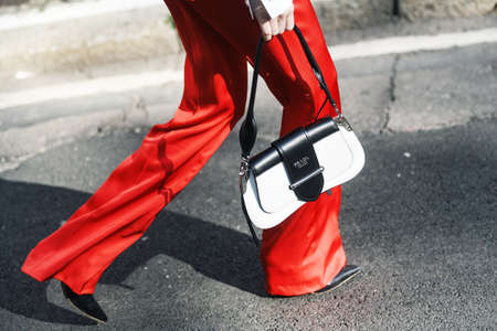 Milan, Italy - February 22, 2019: Street style outfit - Prada purse after a fashion show during...