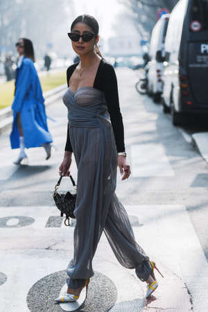 Milan, Italy - February 21, 2019: Street style â Women wearing a Dior purse before a fashion show during Milan Fashion Week - MFWFW19のeditorial素材