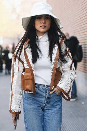 Milan, Italy - February 21, 2019: Street style â Women wearing a Fendi raincoat before a fashion show during Milan Fashion Week - MFWFW19のeditorial素材