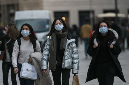 Milan, Italy - February 23, 2020: Coronavirus emergency in Milan, citizens and tourists stroll through the city center wearing protective masks.のeditorial素材