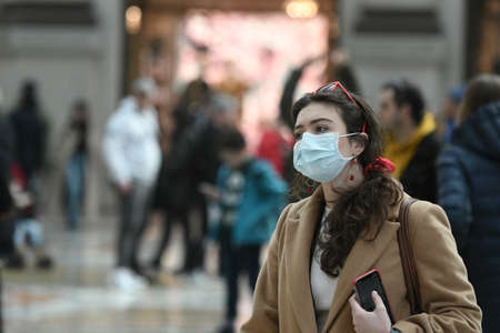 Milan, Italy - February 23, 2020: Coronavirus emergency in Milan, citizens and tourists stroll through the city center wearing protective masks.のeditorial素材