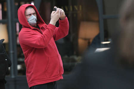 Milan, Italy - February 23, 2020: Coronavirus emergency in Milan, citizens and tourists stroll through the city center wearing protective masks.のeditorial素材