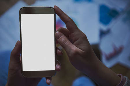 girl holding a smartphone with white copy space - home conceptの写真素材