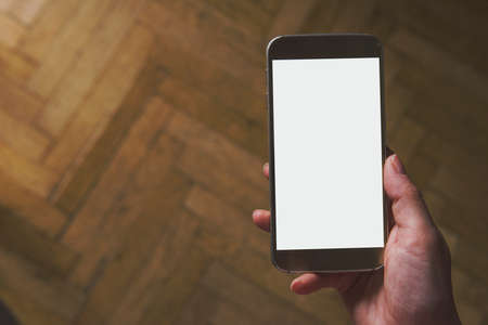 girl holding a smartphone with white copy space - home conceptの写真素材