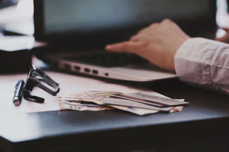 woman holding credit card and using laptop - online shopping conceptの写真素材