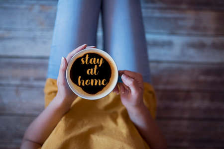 stay at home message in a coffee cup during covid-19 outbreakの写真素材