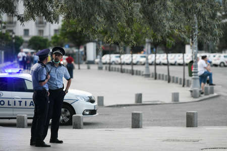 Bucharest, Romania - 16 May 2020: Police officers on Calea Victoriei on the second day of alert caused by the COVID-19 pandemic, in Bucharest.のeditorial素材