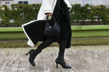 Paris, France â March 2, 2020: Woman wearing a black Prada handbag - streetstylefw20のeditorial素材