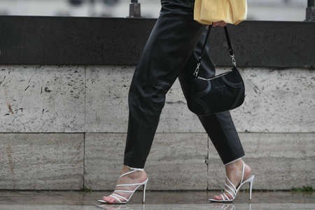 Paris, France â March 2, 2020: Woman wearing black leather trousers, white high heel sandals and a black Prada handbag - streetstylefw20のeditorial素材