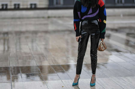 Paris, France â March 2, 2020: Woman wearing a knitted sweater, leather trousers, snake print handbag and patterned high heels - streetstylefw20のeditorial素材