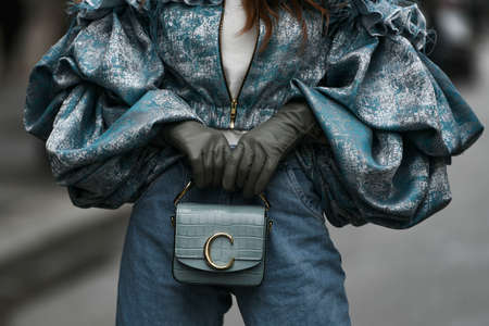 Paris, France â March 2, 2020: Blue oversized bouffant jacket with ruffles, grey leather gloves and dusty blue leather handbag  - streetstylefw20のeditorial素材