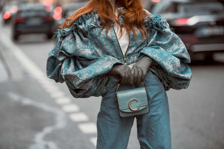 Paris, France â March 2, 2020: Blue oversized bouffant jacket with ruffles, grey leather gloves and dusty blue leather handbag  - streetstylefw20のeditorial素材