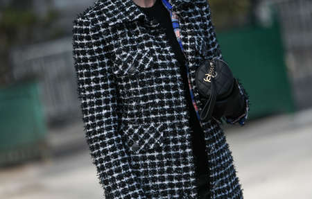 Paris, France â March 3, 2020: Black leather Chanel bag with chain logo detail - streetstylefw20のeditorial素材