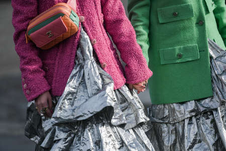 Paris, France â March 3, 2020: Women wearing pink and green blazers and silver ruffled maxi dresses detail - streetstylefw20のeditorial素材