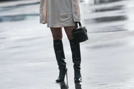 Paris, France â March 3, 2020: Black leather Chanel handbag and black leather knee high high heel boots - streetstylefw20のeditorial素材
