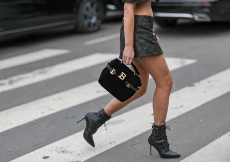 Paris, France - February 28, 2020: Woman wearing a black Balmain handbag - streetstylefw20のeditorial素材
