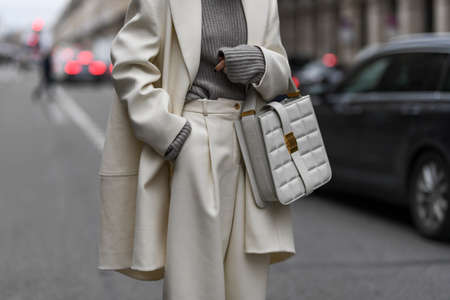 Paris, France - February 28, 2020: Detail of an oversized two piece set and an ivory leather handbag - streetstylefw20のeditorial素材