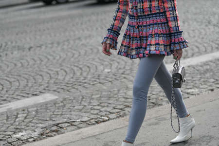 Paris, France â March 3, 2020: Woman wearing a colorful pleated blazer, grey tights and a silver Chanel chain bag - streetstylefw20のeditorial素材
