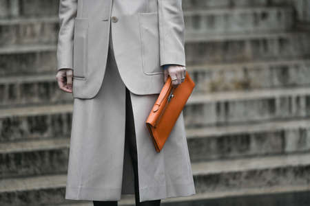 Paris, France â March 2, 2020: Orange leather clutch bag detail - streetstylefw20のeditorial素材