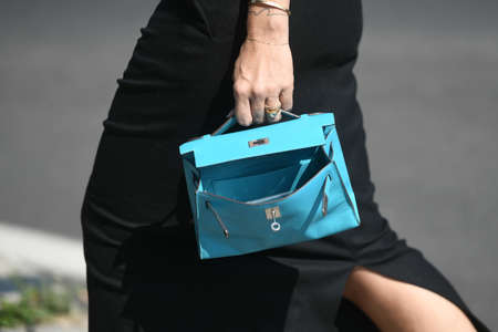 Milan, Italy - September 24, 2021:  Street style outfit, fashionable woman wearing blue Prada handbag on the streets of Milan, Italy.のeditorial素材