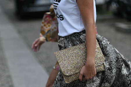Milan, Italy - September 22, 2021:  Street style outfit, woman man wearing a fashionable outfit, purse detail on the streets of Milan, Italy.のeditorial素材