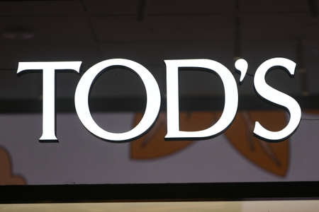 Milan, Italy - September 24, 2021: Tod's logo displayed on a facade of a store in Milan.のeditorial素材
