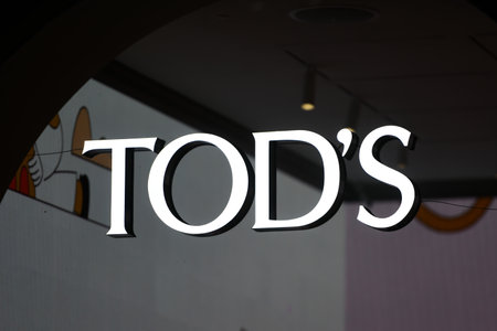 Milan, Italy - September 24, 2021: Tod's logo displayed on a facade of a store in Milan.のeditorial素材