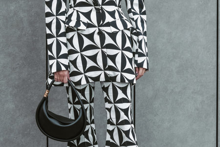 Milan, Italy - February 24, 2022: Street style, woman wearing optical black and white outfit.のeditorial素材