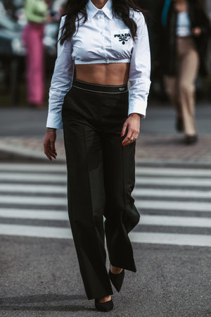 Milan, Italy - February, 24: Street style, woman wearing Prada cropped white shirt and Prada black pants.のeditorial素材