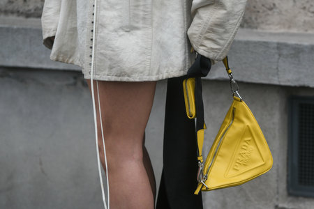 Milan, Italy - February, 24: Street style, woman wearing beige leather jacket, yellow Prada bag and lime green Prada heels.のeditorial素材