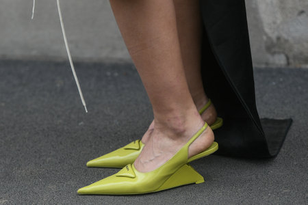 Milan, Italy - February, 24: Street style, woman wearing beige leather jacket, yellow Prada bag and lime green Prada heels.のeditorial素材
