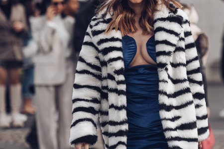 Milan, Italy - February, 24: Street style, woman wearing black and white zebra print pattern oversized fur coat and blue short tube velvet dress.のeditorial素材