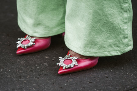 Milan, Italy - February, 24: Street style, woman wearing green pants and pink shoes.のeditorial素材
