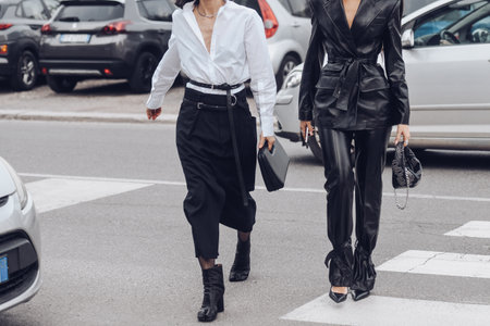 Milan, Italy - February, 24: Street style, woman wearing white V-neck shirt and black leather pants.のeditorial素材