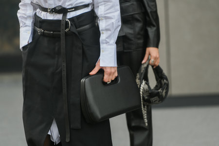 Milan, Italy - February, 24: Street style, woman wearing white V-neck shirt and black leather pants.のeditorial素材