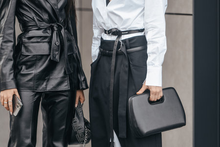 Milan, Italy - February, 24: Street style, woman wearing white V-neck shirt and black leather pants.のeditorial素材