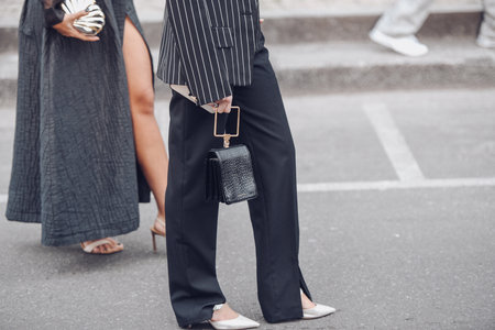 Milan, Italy - February 25, 2022: Street style, woman wearing fashionable outfit.のeditorial素材
