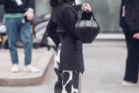 Milan, Italy - February 25, 2022: Street style, woman wearing fashionable outfit.のeditorial素材