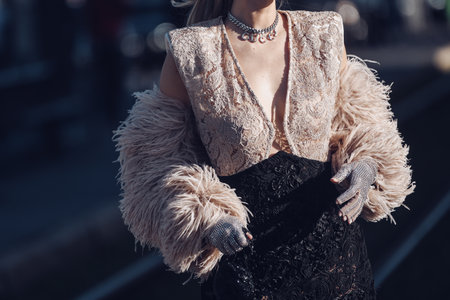 Milan, Italy - February 25, 2022: Female in stylish lace clothes with fur sleeves in Milan.