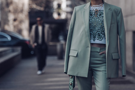 Milan, Italy - February 25, 2022: Female wearing a light green blazer, ornamental shirt and matching ornamental handbag.のeditorial素材