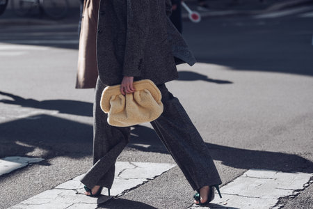 Milan, Italy - February 25, 2022: Woman in trendy wool suit with palazzo pants and high heels.のeditorial素材