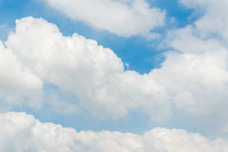 Fluffy white clouds in blue sky