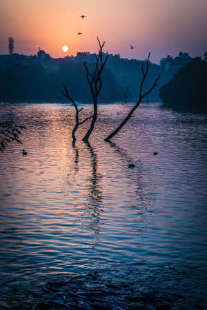 Sun is rising at Hauz Khas Lake in autumn seasonの写真素材