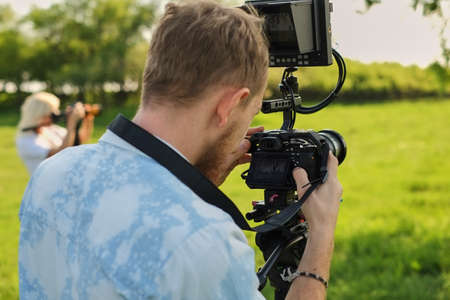professional videographer recording with a professional video camera decoder and broadcast.の写真素材